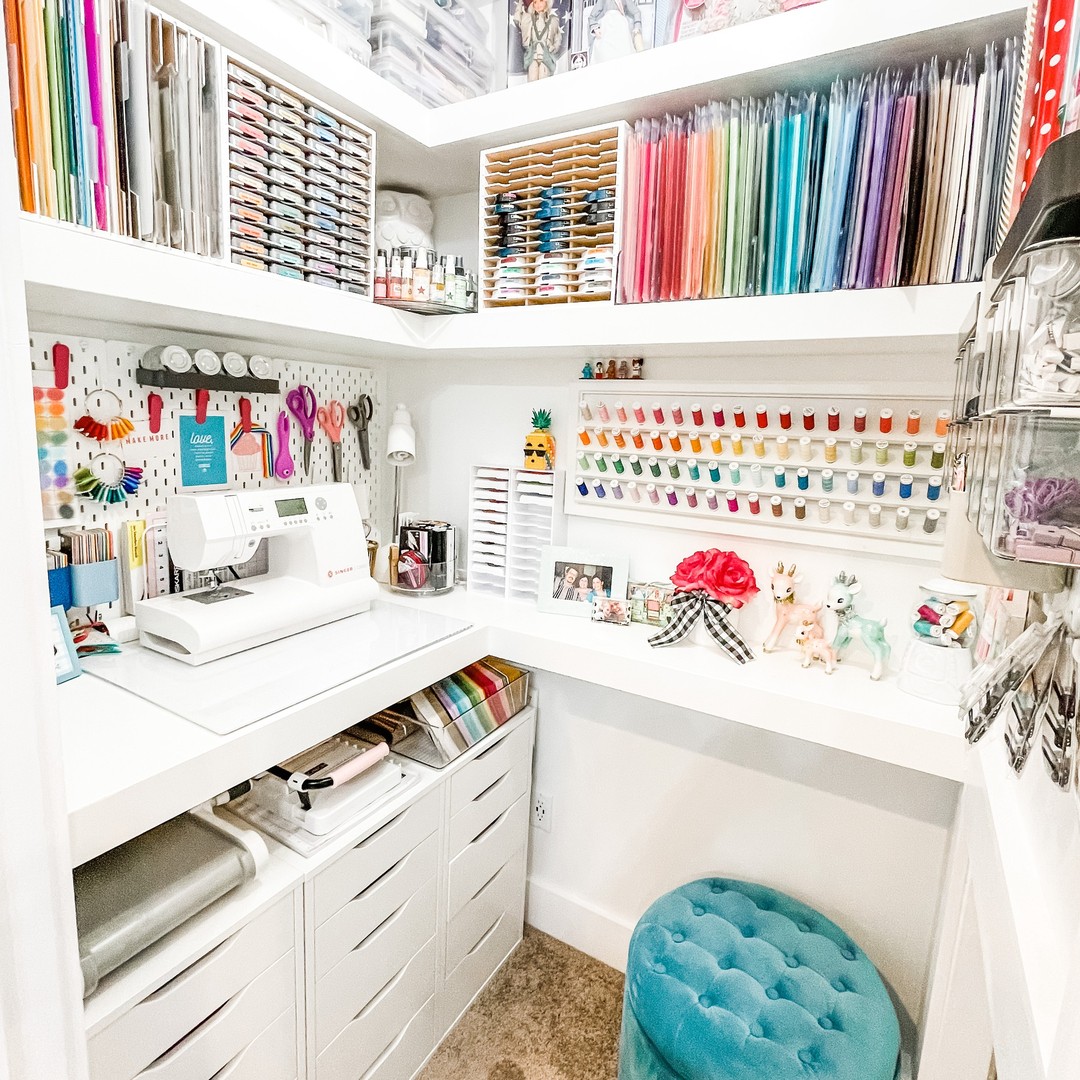 Compact craft closet corner with stacked shelves and a small pegboard