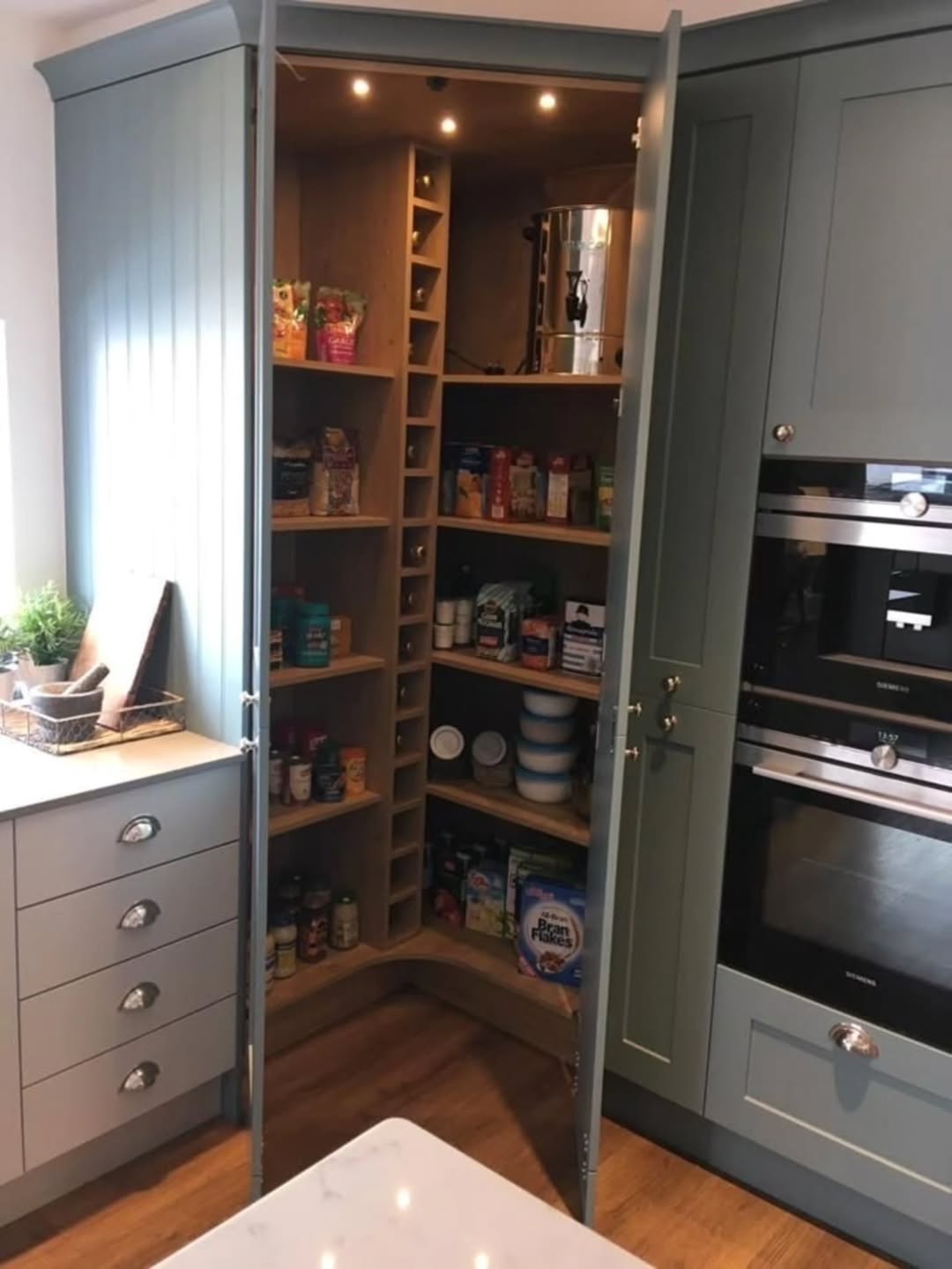 Blue-gray corner pantry with a vertical wine rack and open shelving