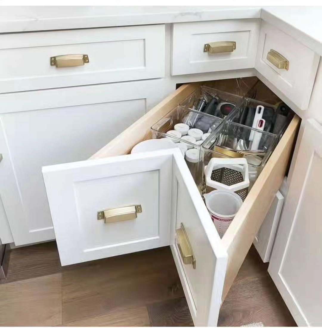 White angled corner drawers with clear plastic organizer bins