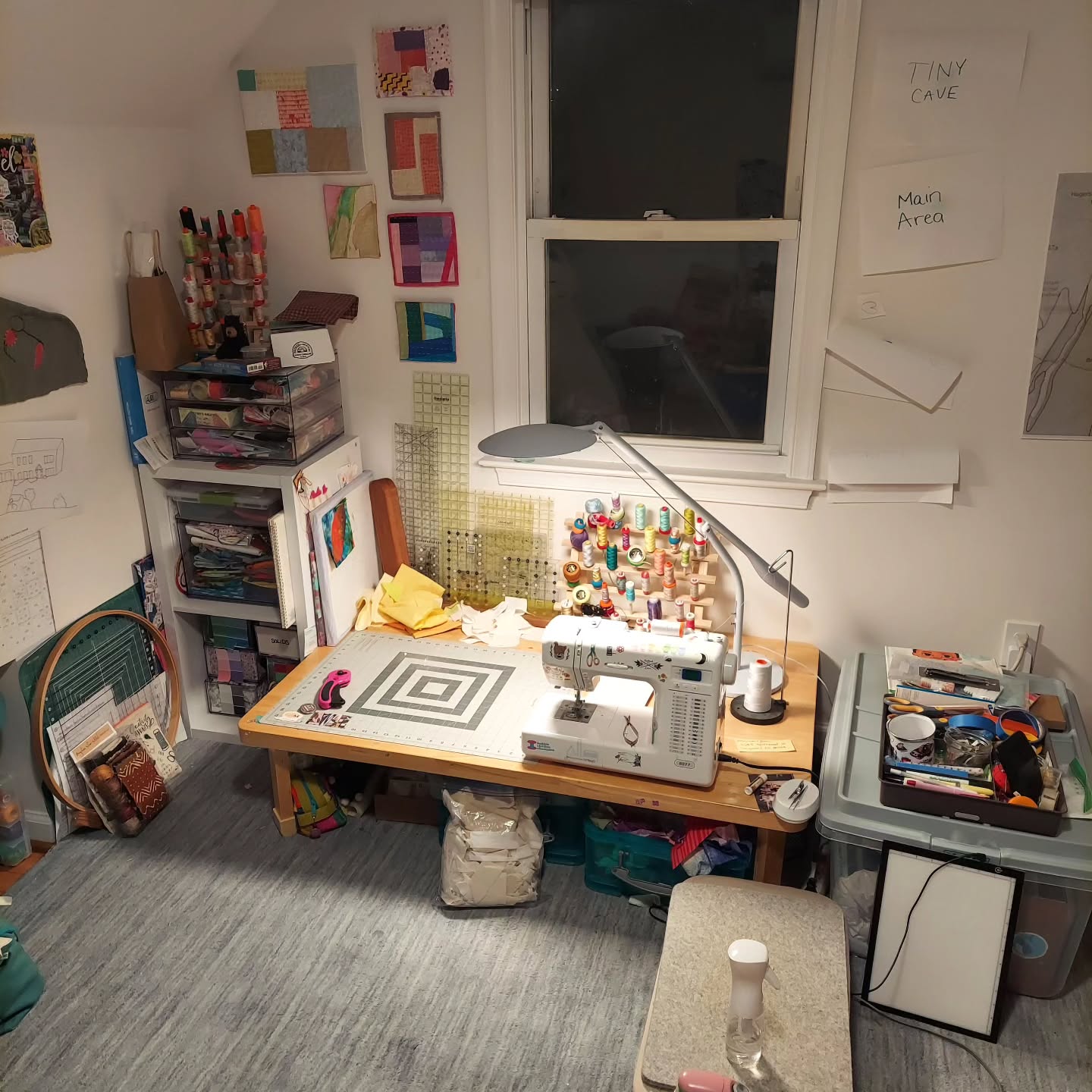 Attic sewing desk with hand-labeled Tiny Cave and Main Area signs