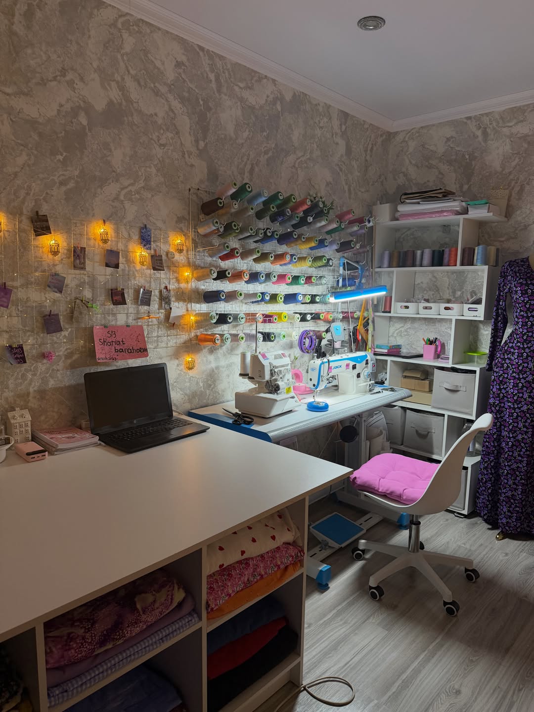 Sewing studio with a wall display of colorful thread spools
