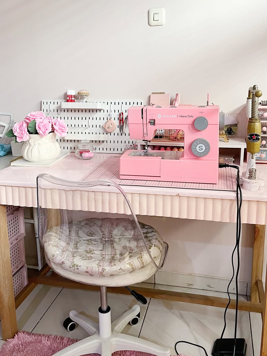 Pink Singer sewing machine on a ruffled pink desk